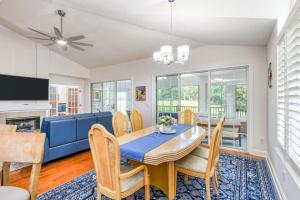 a dining room with a blue table and chairs at Spacious 3 BR plus SS in Den & screened lanai waterside in Sampson