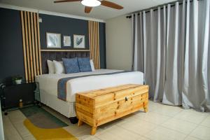 a bedroom with a bed with a wooden box next to it at Kanana Villas - Maun 2 bedroom apartment in Maun