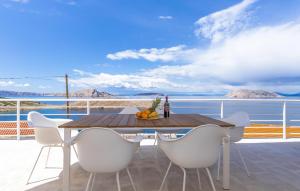 a table and chairs on a balcony with a view of the ocean at 2 Bedroom Amazing Apartment In Lukovo in Lukovo +16 photos
