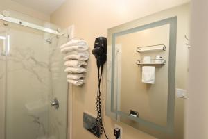 a bathroom with a shower with a phone in it at Casa Loma Hotel in San Francisco