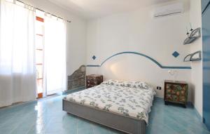 a bedroom with a bed in a blue and white room at Il Giardino Dei Filosofi in Ascea