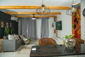 a living room with a couch and a table at Kanana Villas - Maun 2 bedroom apartment in Maun
