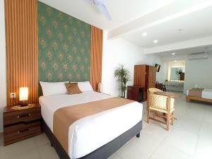 a bedroom with a bed and a desk and a chair at Punta Colibrí in Brisas de Zicatela