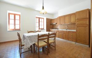 a kitchen with a table and some chairs and a table at Il Giardino Dei Filosofi in Ascea