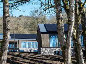 a house with solar panels on the side of it at Villa in Belgium with Private Terrace in La Roche-en-Ardenne