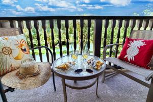 a table and chairs on a balcony with glasses of wine at 5305-1 Summer Fun in this 1BR at Laterra-pool view in Saint Augustine
