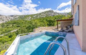 a swimming pool with a view of a mountain at 2 Bedroom Lovely Apartment In Lukovo in Lukovo