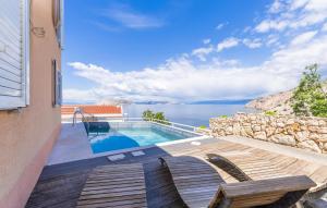 a villa with a swimming pool and a view of the ocean at 2 Bedroom Lovely Apartment In Lukovo in Lukovo +19 photos