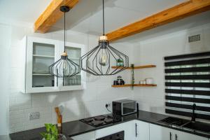a kitchen with two chandeliers above a kitchen counter at Kanana Villas - Maun 2 bedroom apartment in Maun