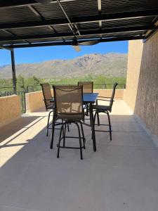 a table and chairs on a patio with a view at Tucson's Hot Springs At The Oasis in Tucson