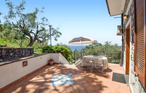 a balcony with a table and an umbrella at Il Giardino Dei Filosofi in Ascea
