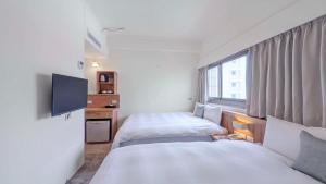 Postel nebo postele na pokoji v ubytování Foung Gu Hotel