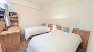 Postel nebo postele na pokoji v ubytování Foung Gu Hotel