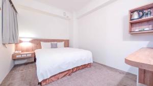 Postel nebo postele na pokoji v ubytování Foung Gu Hotel