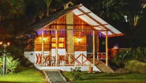 a small log cabin with christmas lights on it at Ecohotel in Armenia