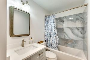 a white bathroom with a sink and a mirror at Mtn-View Deck Scenic Conway Log Cabin! in Conway