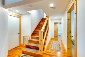 a staircase in a home with white walls and wooden floors at Mtn-View Deck Scenic Conway Log Cabin! in Conway