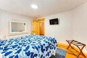 a bedroom with a bed and a tv on the wall at Mtn-View Deck Scenic Conway Log Cabin! in Conway
