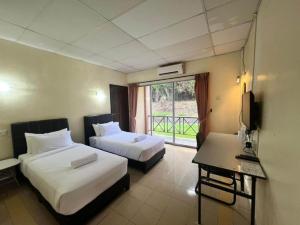 Ένα ή περισσότερα κρεβάτια σε δωμάτιο στο USAS Resort, Kuala Kangsar