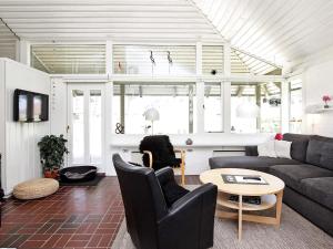 a living room with a couch and a table at 5 person holiday home on a holiday park in Karrebæksminde in Karrebæksminde +60 photos
