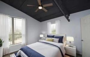 Un dormitorio con una cama y un ventilador de techo. en Family Experiences - Fishing Archery Unit C, en Cookson