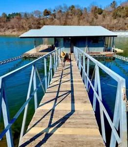 un muelle con un edificio sobre el agua en Family Experiences - Fishing Archery Unit C, en Cookson 4 fotos más