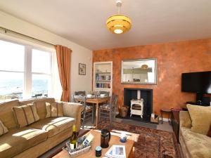 a living room with a couch and a table at 2 Bed in Anstruther 80648 in Pittenweem