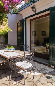 a table and chairs on a patio with a window at Villa Santa Sofia in Vico Equense