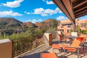 a balcony with chairs and tables with mountains in the background at Hot tub Game room stargazing and mountain views at Happy Javelina in Sedona