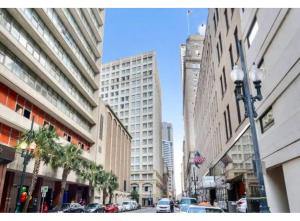 a city street with cars parked on a street with buildings at Legacy BnB Suites in New Orleans