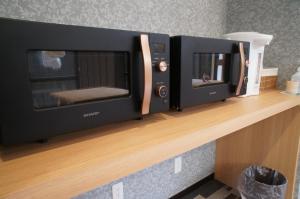two microwaves sitting on a wooden counter at 白浜の宿梅 in Shirahama +35 photos