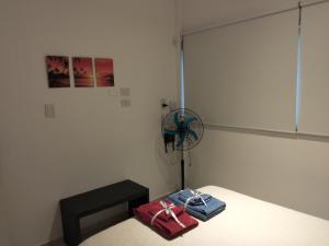 a room with a bed with a fan and towels at Dpto San Javier in Yerba Buena