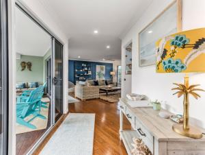 a kitchen and living room with a table and chairs at Seascape - Pet Friendly in Kingscliff