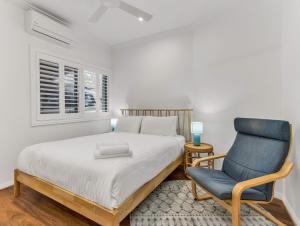a bedroom with a bed and a blue chair at Seascape - Pet Friendly in Kingscliff +28 photos