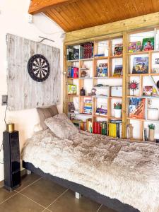 a bedroom with a bed and a dartboard on the wall at Authentic house with playroom and infrared sauna in Bilzen