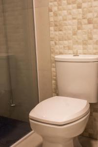 a bathroom with a toilet and a shower at apto Casal Canela in Canela