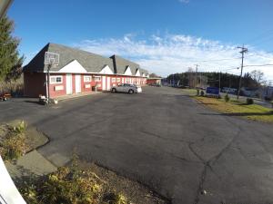 a parking lot with a car parked in front of a building at Castle Inn East Greenbush Castleton-on-hudson in East Greenbush