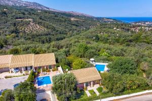 an aerial view of a villa with a mountain at Villa Maistro Cottage by Villa Plus in Ágios Stéfanos