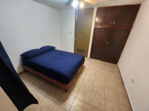 a bedroom with a blue bed and a closet at Your charming vacation home, all to yourself! in Monterrey
