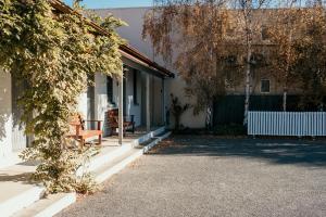 a house with a bench on the side of it at Caledonian Inn - The Stump in Port Fairy +21 photos
