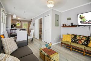 a living room with a couch and a table at Bogeys Retreat by AvantStay Golfers Retreat w Shared Pool Month Long Stays Only in Stock Island
