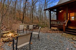 a group of chairs sitting outside of a cabin at Tree Top Hideaway - Private with Games Firepit More in Blue Ridge