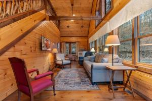 a living room with a couch and a table at Tree Top Hideaway - Private with Games Firepit More in Blue Ridge