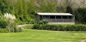 a house in the middle of a green yard at 287 Cafe & Motel in Wairoa