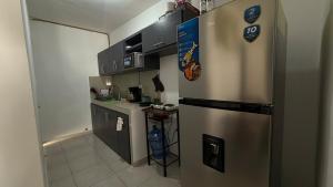 a kitchen with a stainless steel refrigerator and a counter at Apartment 2 min Miramar beach in Tampico