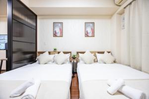 Llit o llits en una habitació de Master Residence Dotonbori Shinsaibashi