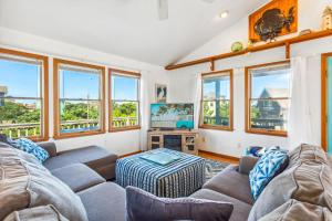 a living room with two couches and a tv at 8342 - Lifesaver's Haven in Avon