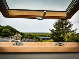 a large window in a room with a bed with a view at 3 Bed in Fairbourne 77304 in Arthog