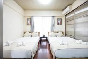 Llit o llits en una habitació de Master Residence Dotonbori Shinsaibashi