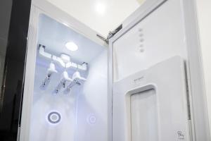 a room with a white refrigerator and some bells at Comport Hotel in Pohang +44 photos